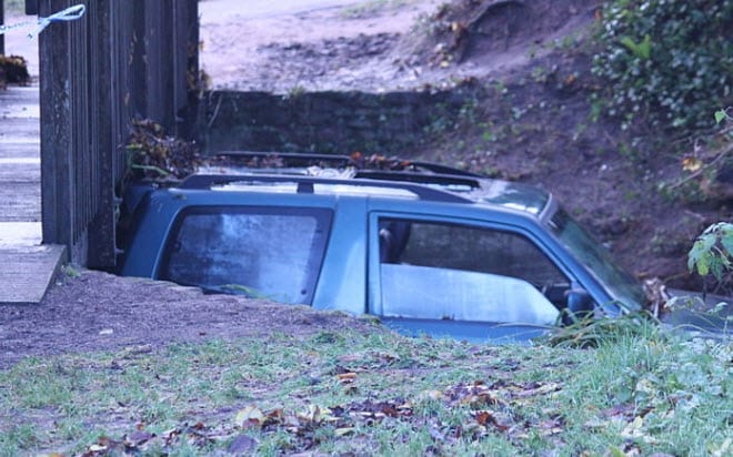 UK Flood Car Trapped under a bridge