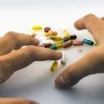 Opioid abuse crisis - Ohio health insurance - hands reaching for pills