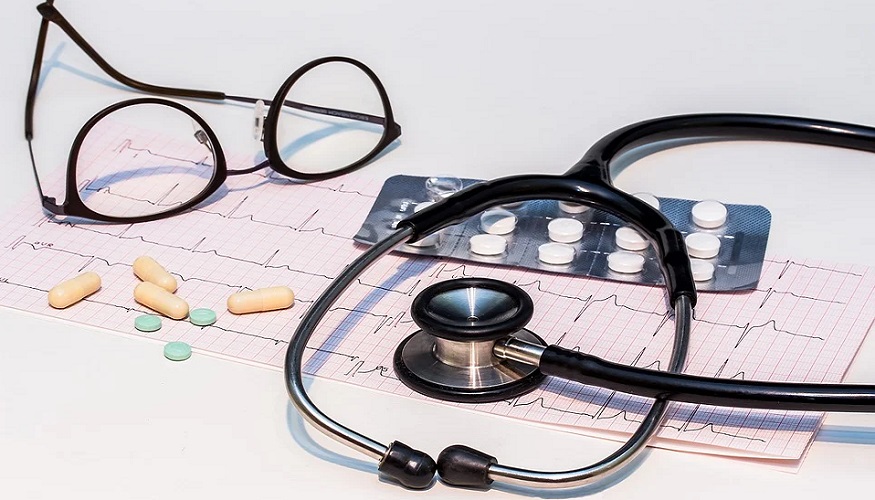 Employer sponsored health insurance - stethoscope - heartbeat monitor - glasses - pills
