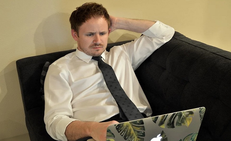 Life insurance policy trends - man looking thoughtful at laptop