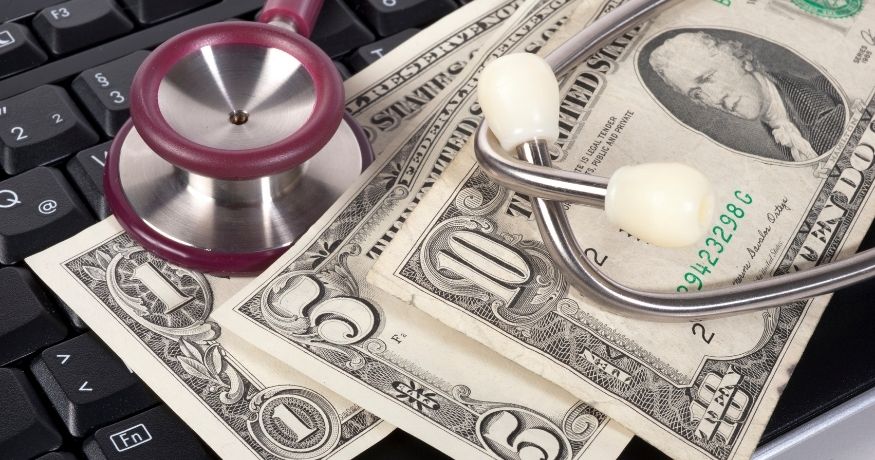 Health insurance - health costs - keyboard - money- stethoscope