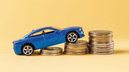 Auto insurance rates - car driving up coins