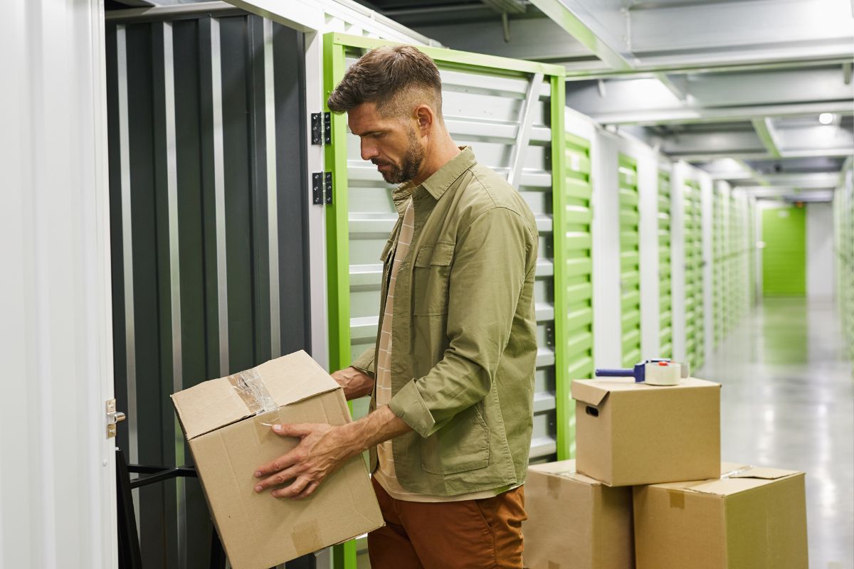 Storage unit insurance - Person adding boxes to storage