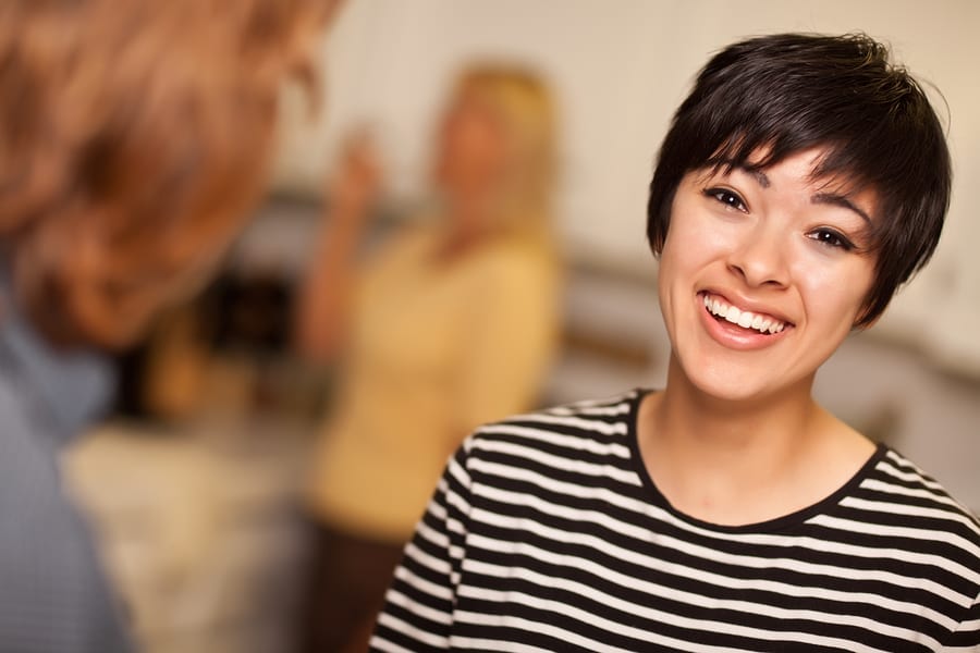 generation y insurance company Laughing Young Woman Socializing in a Party Setting.