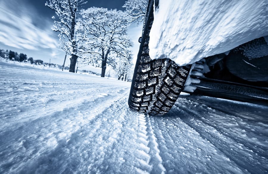 Car tires on winter road air pressure check