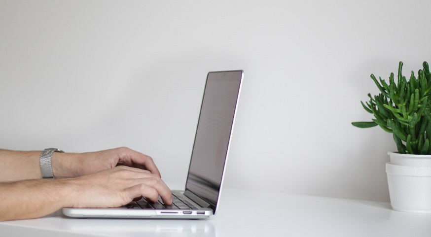 Write Local Insurance News - Person Tying on Computer