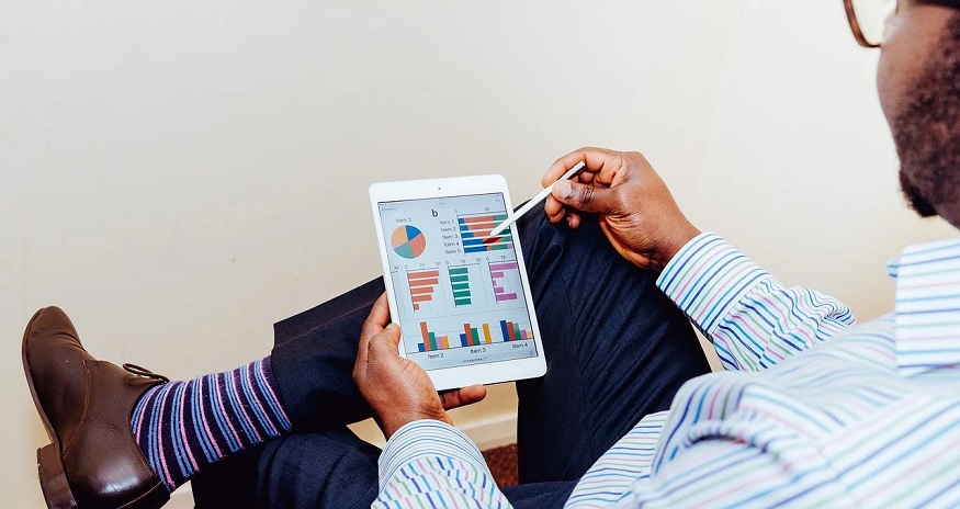 Job-based health insurance - Man studying graph on tablet