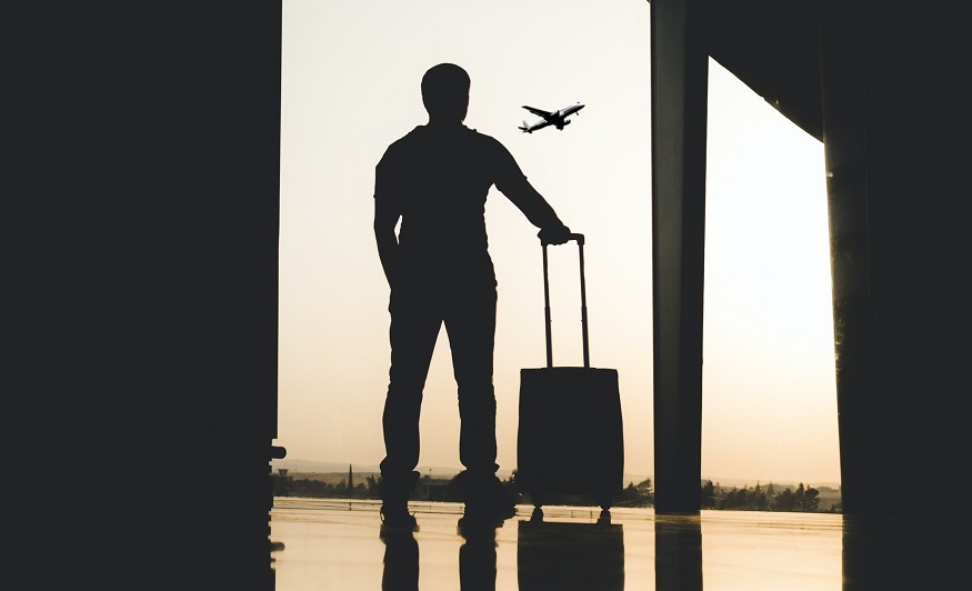 Travel insurance vs protection - person with luggage at airport