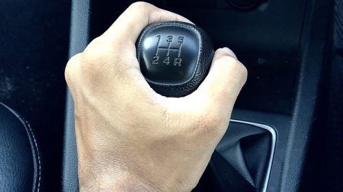 Allstate car insurance rates - hand on gear knob