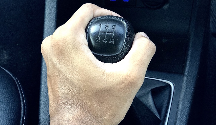 Allstate car insurance rates - hand on gear knob