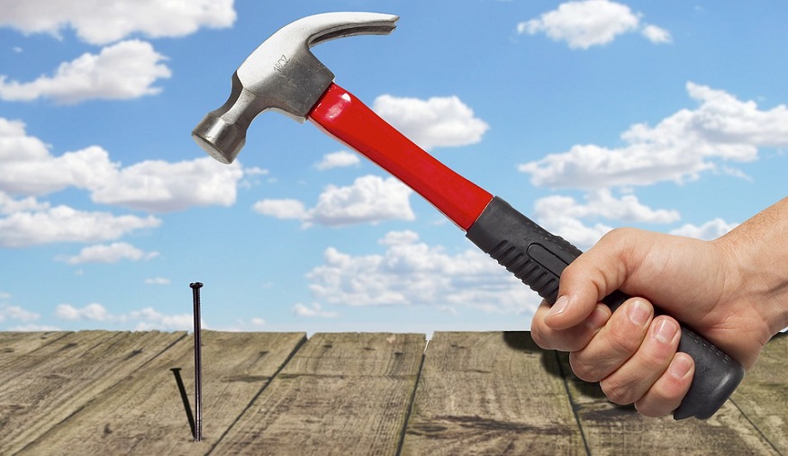Insurance fraud - home repair - hammer and nail