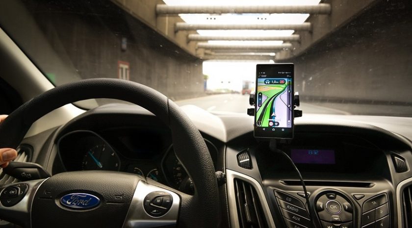 Progressive Insurance Snapshot - Person Driving with GPS on Phone
