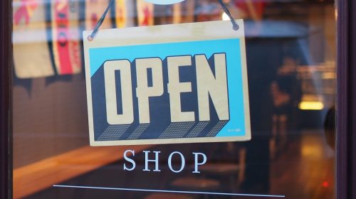 Small business insurance market - Open Sign on Shop Door