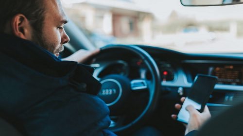 Distracted Driving Awareness Month - Man texting while driving