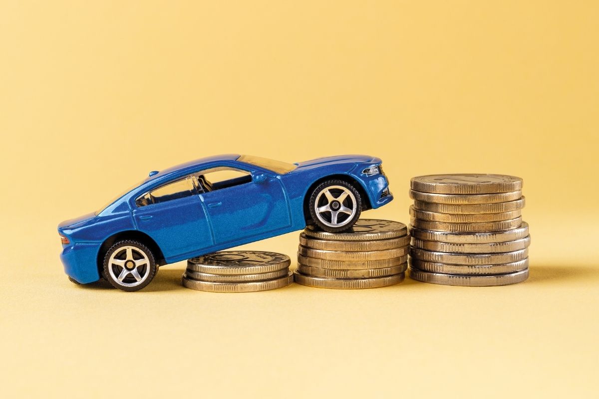 Auto insurance rates - car driving up coins