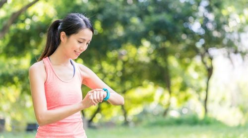 Health insurance company - Woman exercising wearing watch