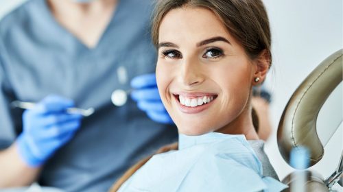 Dental insurance - Woman smiling in dentist office