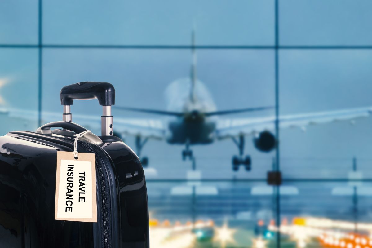 Holiday travel insurance - suitcase - airport