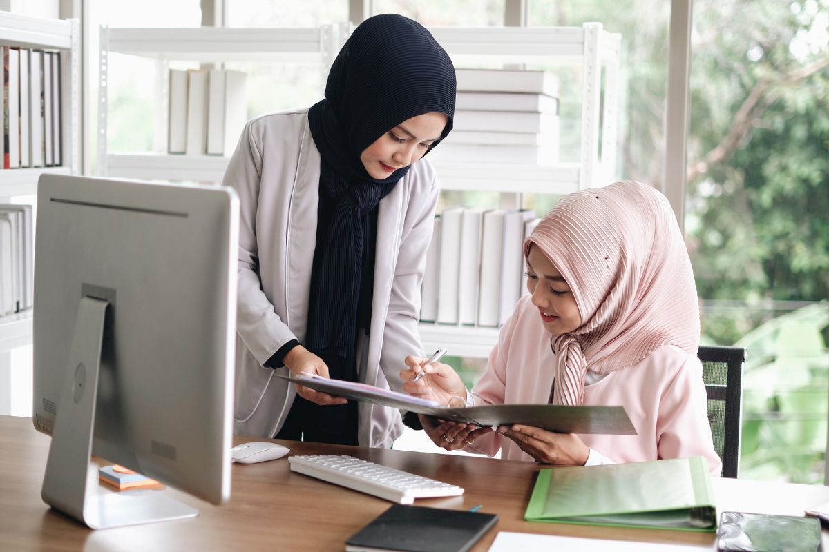 Insurance company - Women in office setting wearing hijabs
