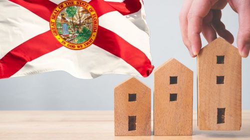 Home insurance Three wooden homes and Florida state flag