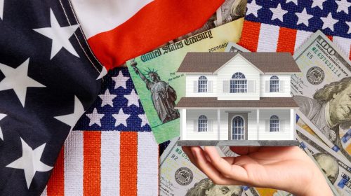 Homeowners insurance - American flag, money, person holding up house